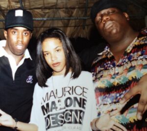 Maurice Malone T-Shirt worn by Aaliyah. Next to Aaliyah is Sean Combs and the Notorious B.I.G.