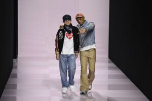 Nigo from Bathing Ape walking the Louis Vuitton Paris Fashion Show with Pharrell Williams